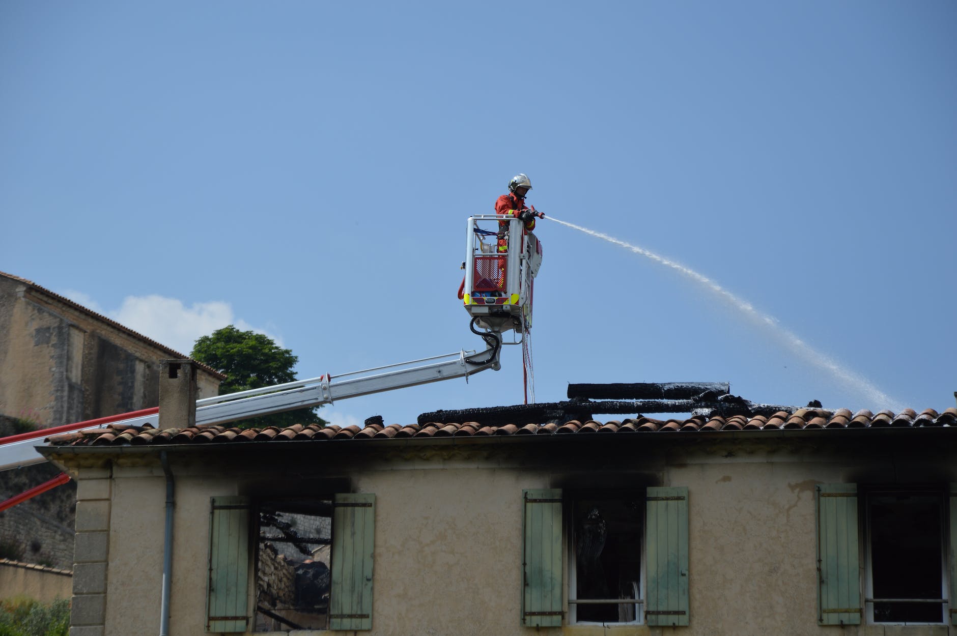 a firefighter hosing the fire